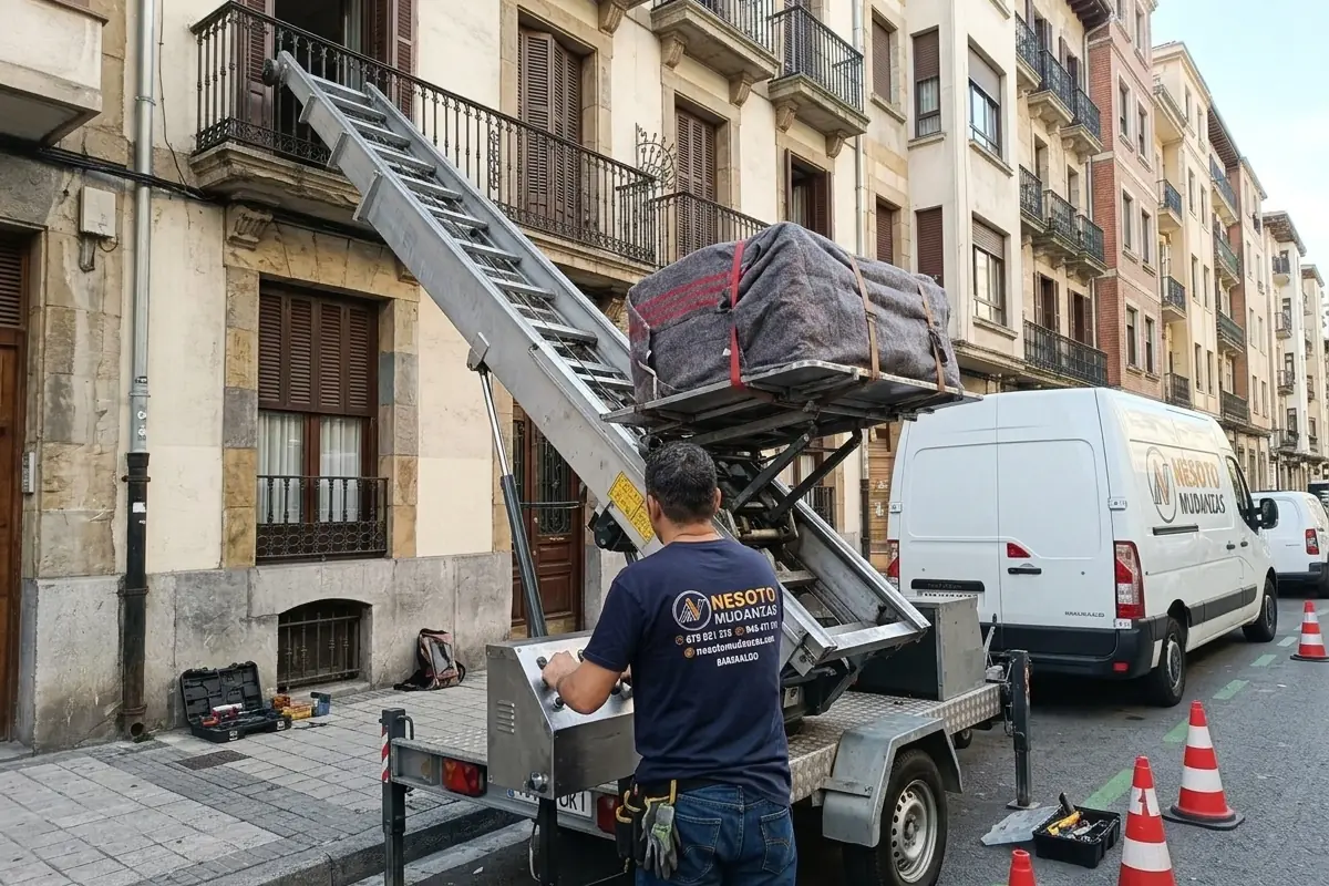 Plataforma elevadora de mudanzas subiendo muebles por la fachada de un edificio en Bizkaia