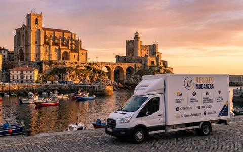 Camión de mudanzas NESOTO en el puerto de Castro Urdiales, con la iglesia de Santa María y el castillo-faro